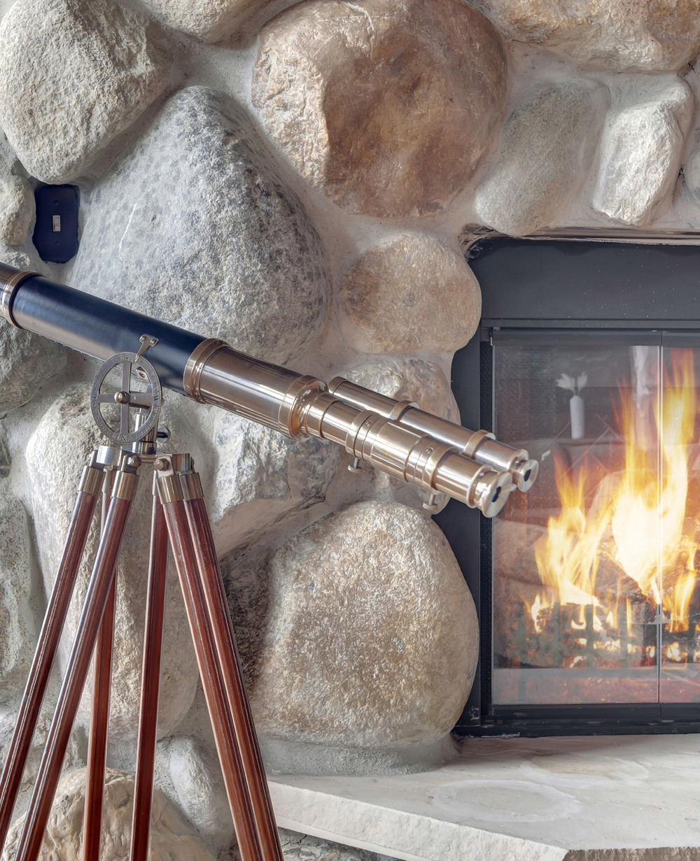 stone fireplace and telescope